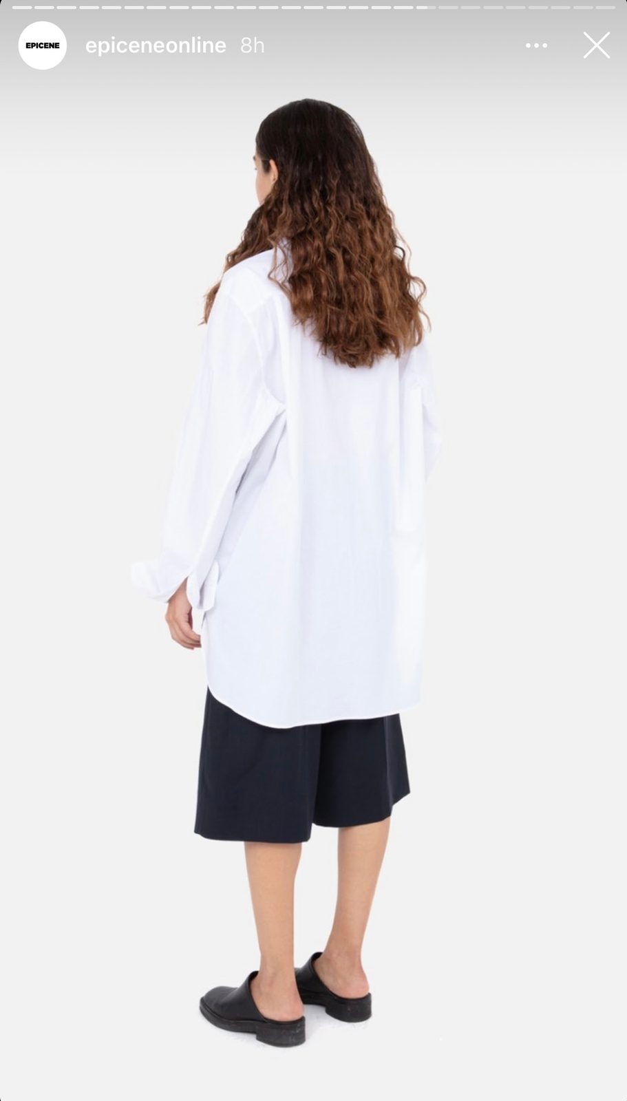 A model in a white shirt photographed from behind, Instagram story frame