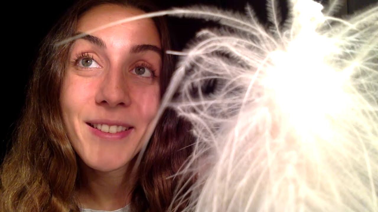 Dila facing the webcam beside a bright sparkler, wide-eyed